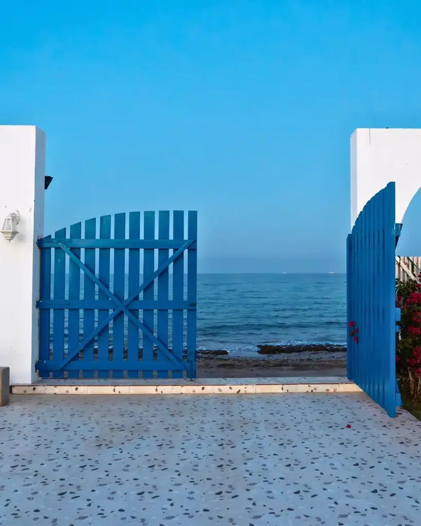 Blue gate opening to the sea