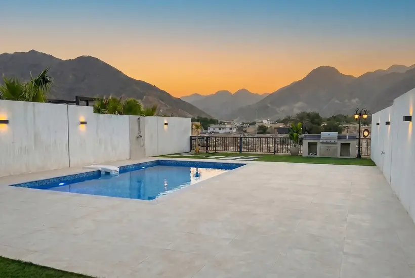 The Bay Villa pool at sunset with the Hajar mountains, Dibba Fujairah