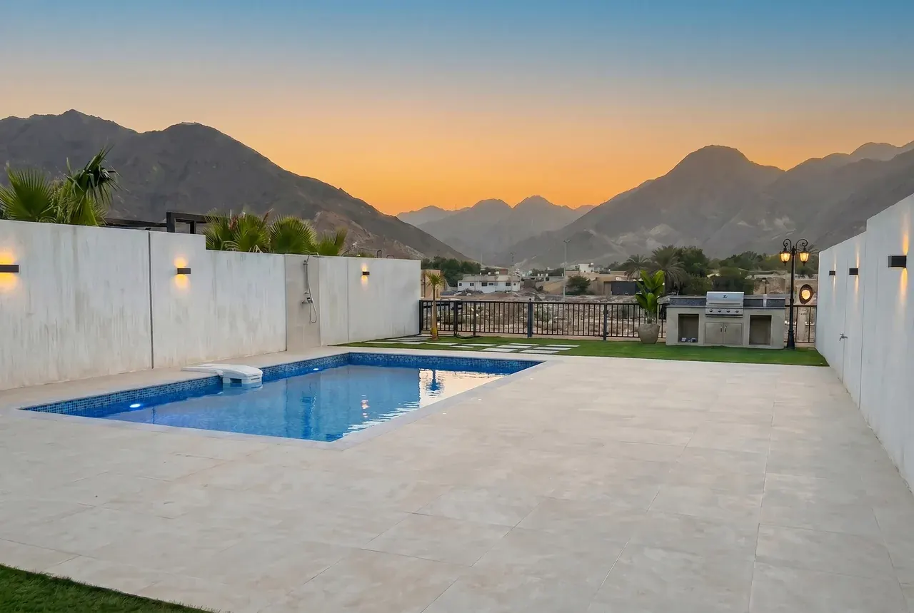 The Bay Villa pool at sunset with the Hajar mountains, Dibba Fujairah