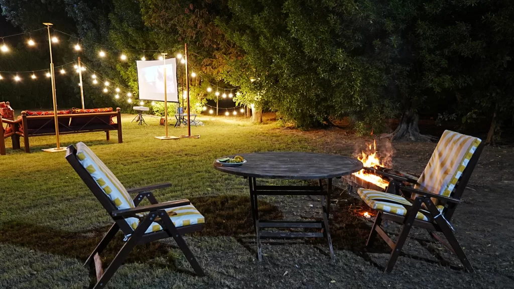 fire and 2 chairs in the greenland farm at night time